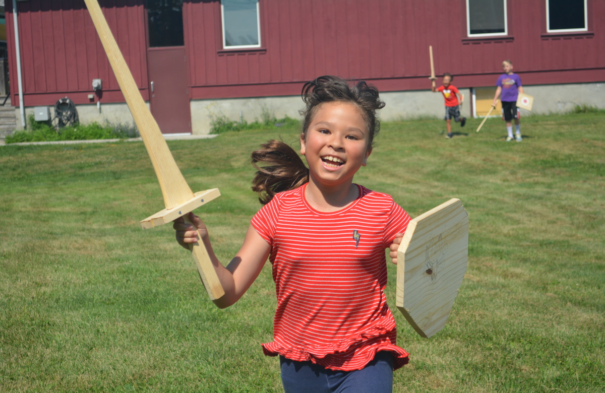 Girl running with sword and shield