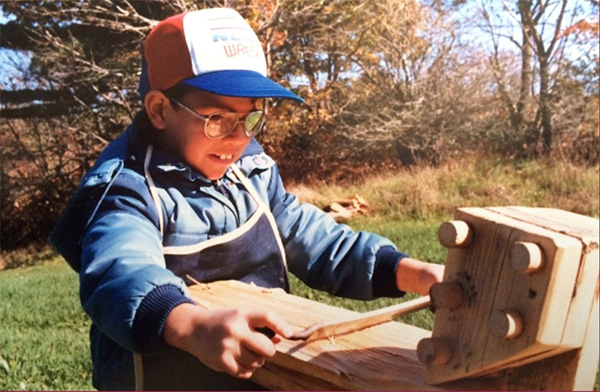 A student from Prince Edward School uses the shaving horse, 1987
