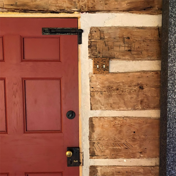 Disassembly marks still visible on the interior walls of the Log House today. 