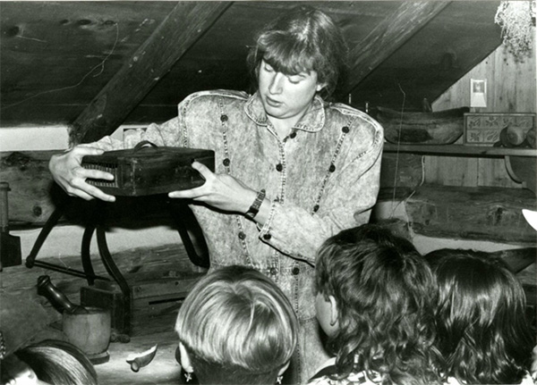Colleen Rock showing a mousetrap from the collection to a group of students from Prince Charles Public School