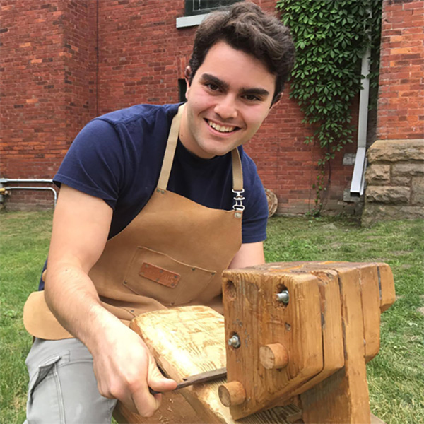 Summer Student demonstrates using the same shaving horse in 2017